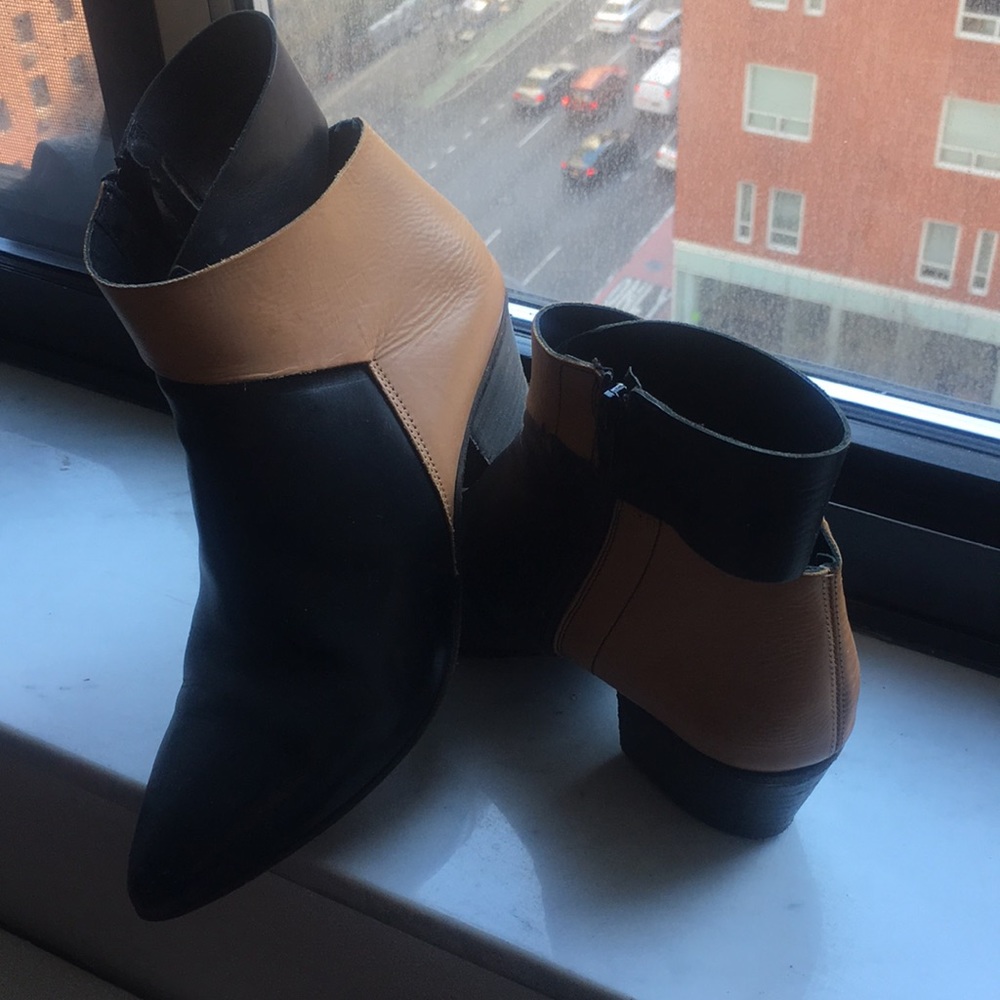 A pair of ankle booties Black and Tan